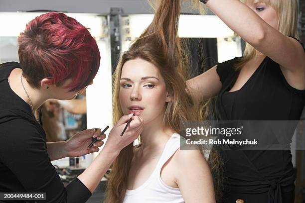 teenage model (16-18) being styled backstage before fashion show - backstage hairdresser stockfoto's en -beelden