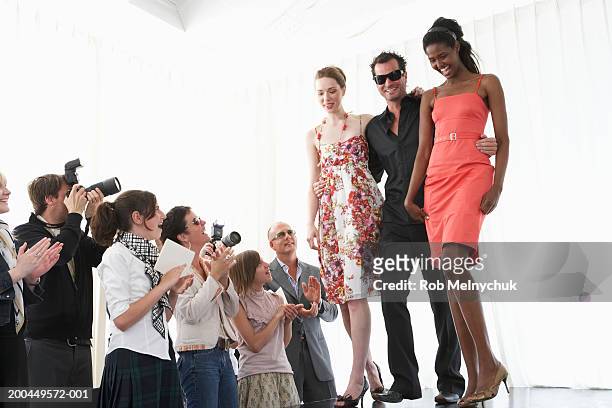 spectators applauding for models and fashion designer on runway - kids catwalk stock pictures, royalty-free photos & images