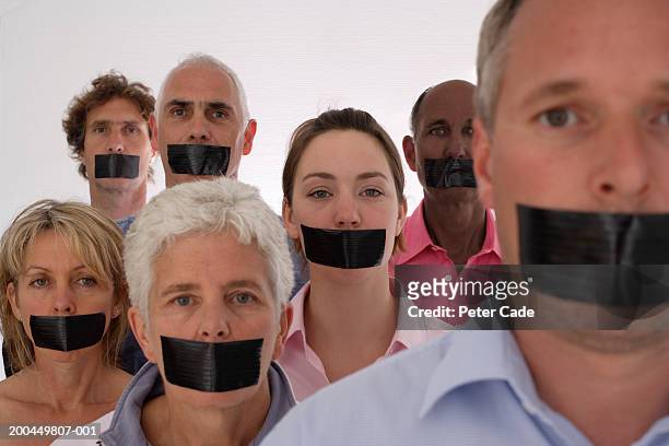 people with black tape over mouths, portrait - censure photos et images de collection