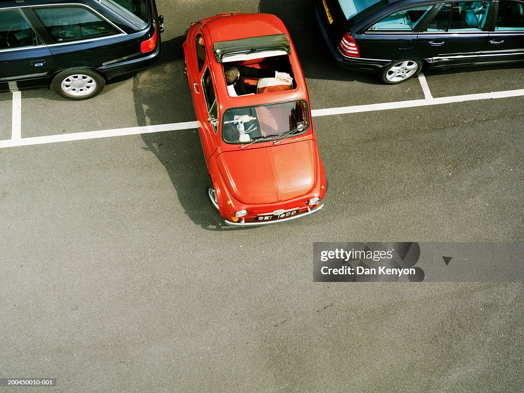 Man parking red car, overhead view