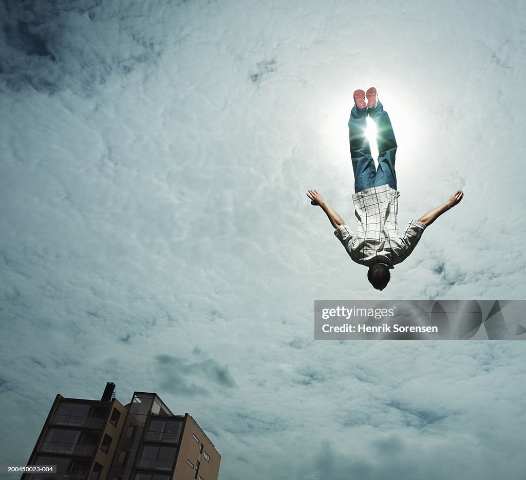 Young man upside down in air, low angle view