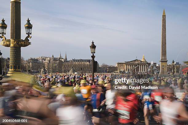 france, paris, runners in paris marathon crossing place de la concorde - la marathon stock pictures, royalty-free photos & images