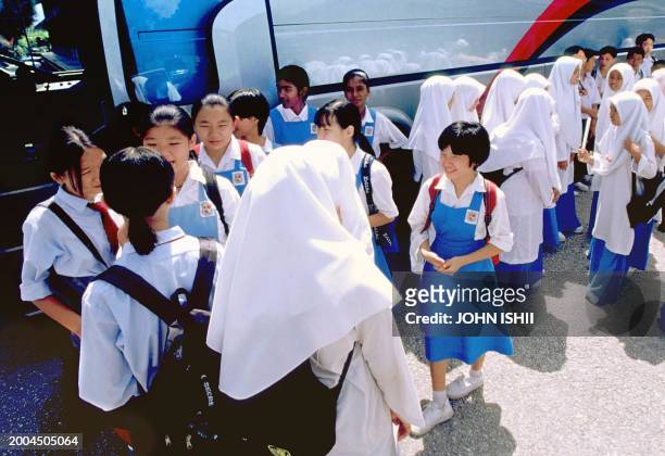 This undated picture taken early 2000 shows Malaysian schoolchildren, some ethnic Chinese and some Muslim, on a field trip near Kuala Lumpur. Alarmed...