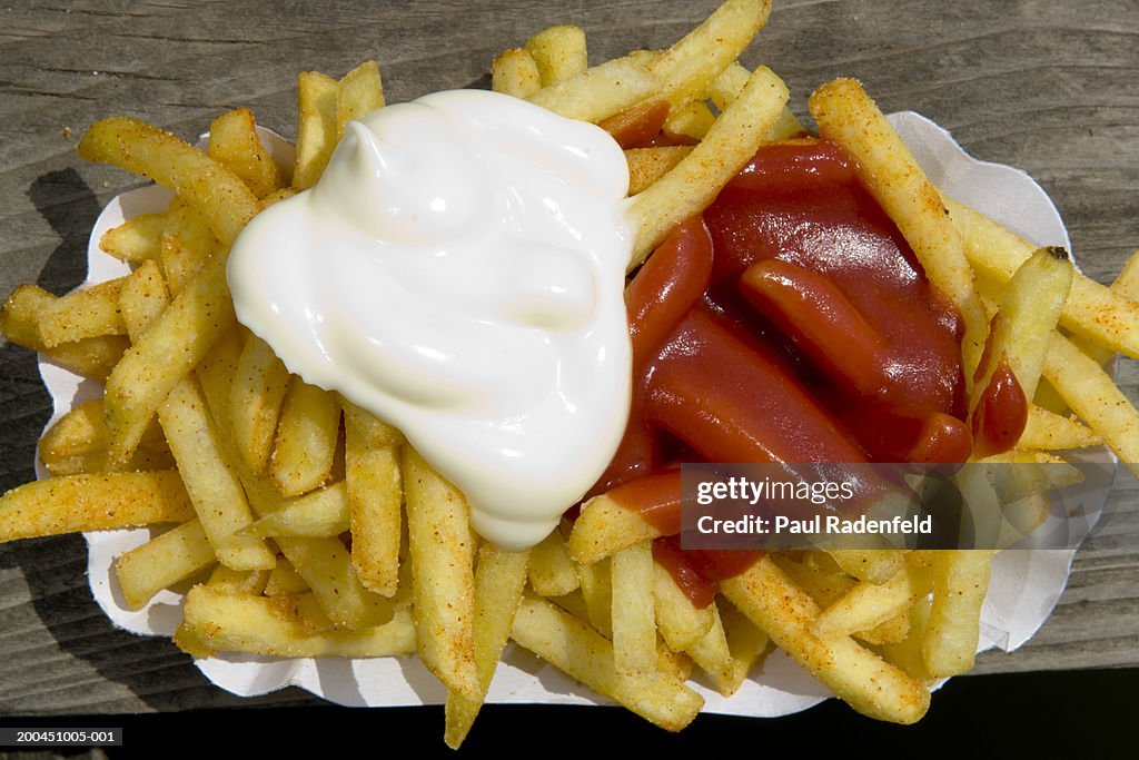 Close-up of chips with mayonnaise and ketchup