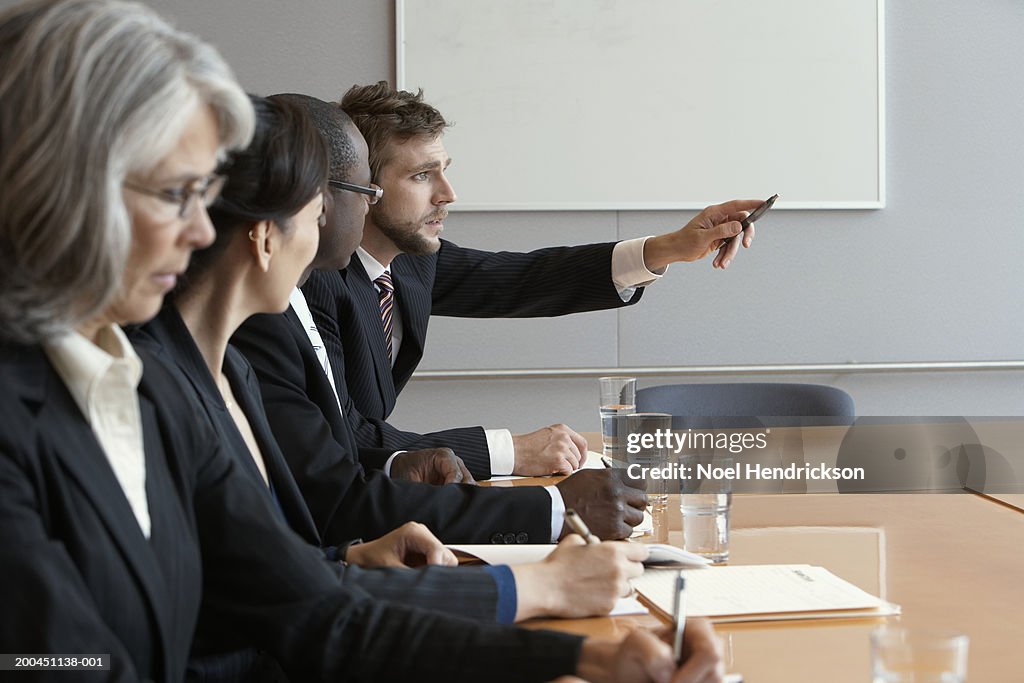 Business colleagues in meeting, man pointing