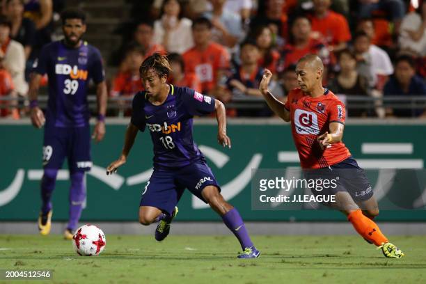 Yoshifumi Kashiwa of Sanfrecce Hiroshima controls the ball against Ryo Okui of Omiya Ardija during the J.League J1 match between Omiya Ardija and...