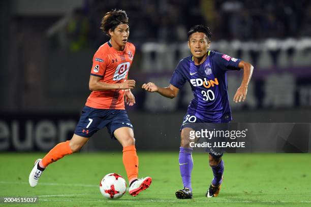 Kosei Shibasaki of Sanfrecce Hiroshima controls the ball against Ataru Esaka of Omiya Ardija during the J.League J1 match between Omiya Ardija and...