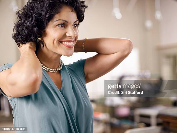 female customer trying on pearl necklace in shop - jewelry stock pictures, royalty-free photos & images