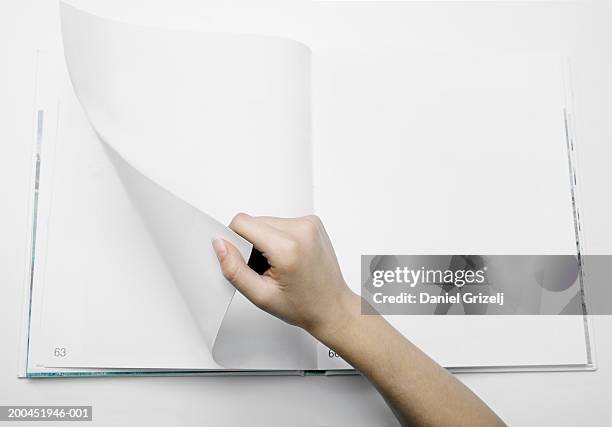 woman turning numbered blank page in photograph album, close-up - turning page stock pictures, royalty-free photos & images