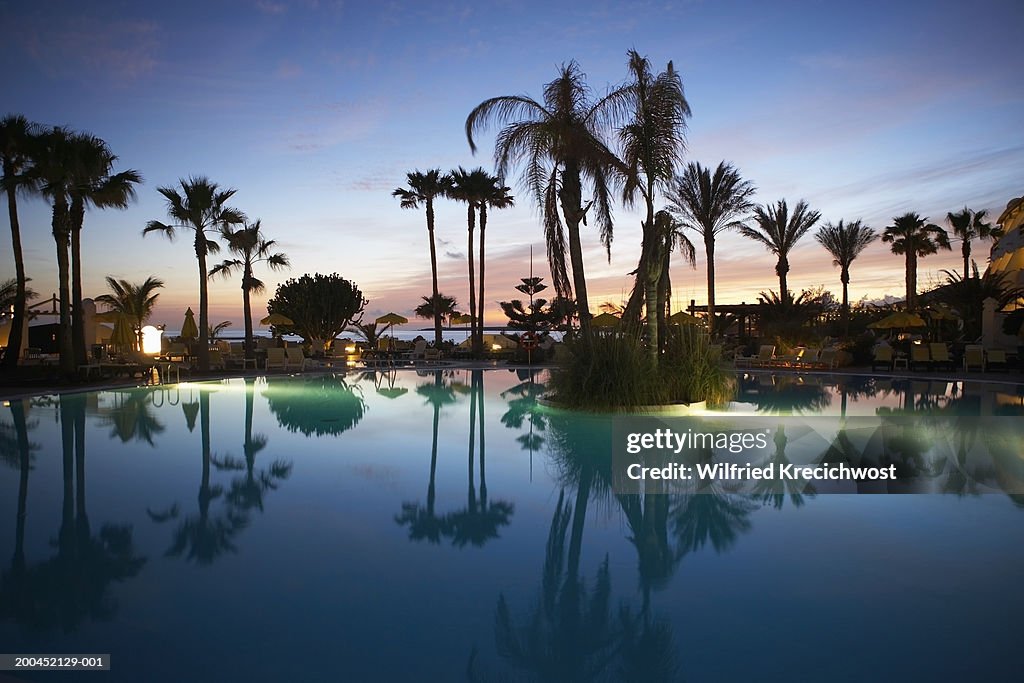 Canary Islands, Lanzarote, swimming pool and palm trees, sunset