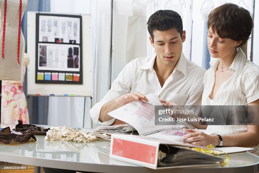 Clothing designers looking at fabric samples