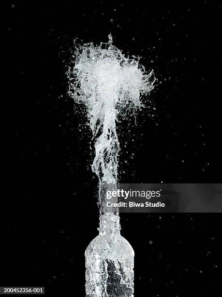 water spraying from bottle - water bottle splash stock pictures, royalty-free photos & images