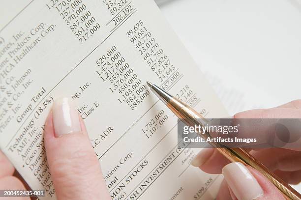 woman reading financial planning report, close-up - statement imagens e fotografias de stock