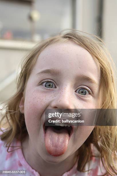 girl (5-7) sticking out tongue, close-up - freckle girl stock pictures, royalty-free photos & images