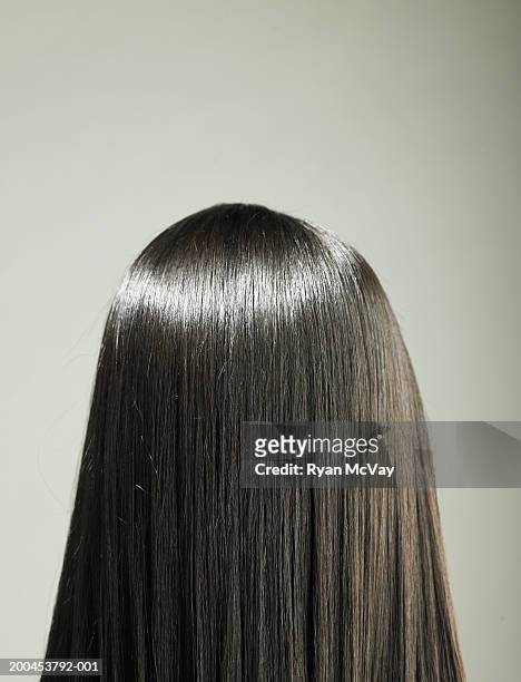 young woman with long hair, rear view - cabello humano fotografías e imágenes de stock