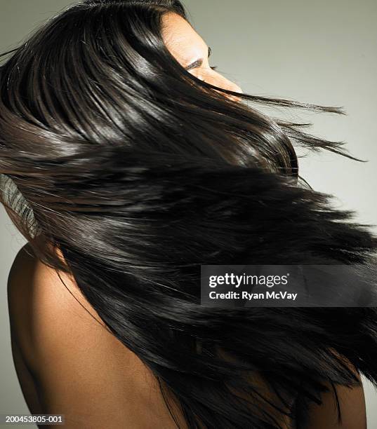 young woman tossing hair, rear view - shiny straight hair stock pictures, royalty-free photos & images