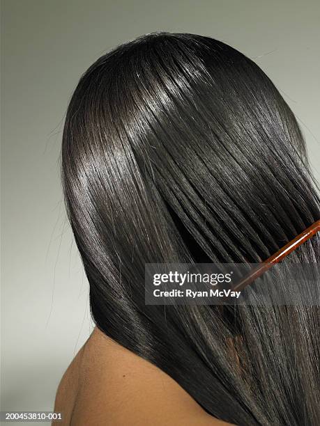 young woman combing hair, side view - shiny straight hair stock pictures, royalty-free photos & images