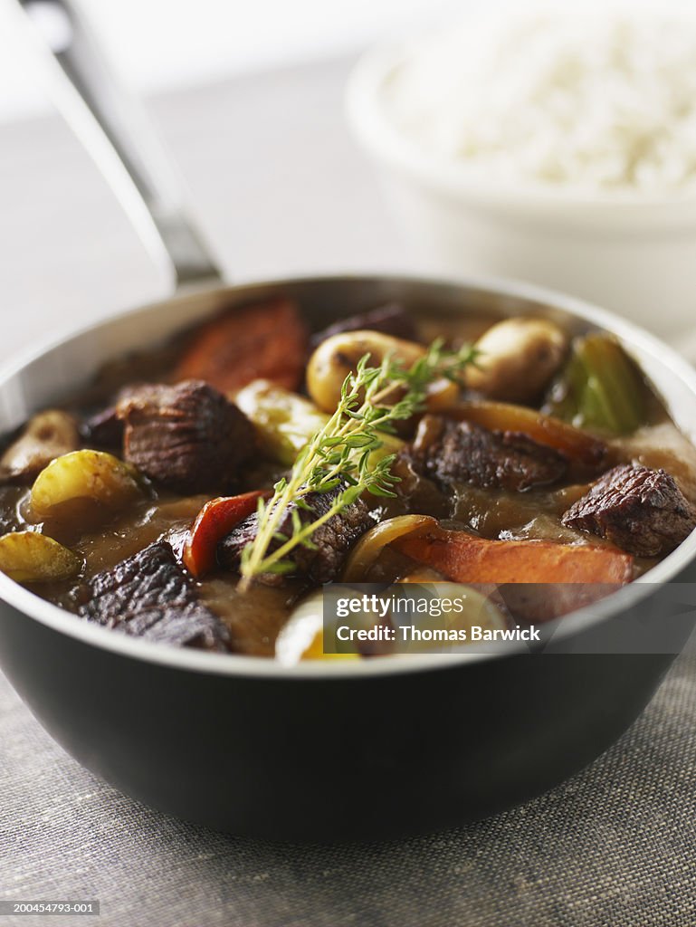 Lamb stew with carrots, potatoes, celery and thyme, rice in background