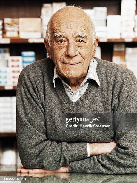 senior man behind counter in tobacconists, leaning on counter,portrait - tobacconists stock pictures, royalty-free photos & images
