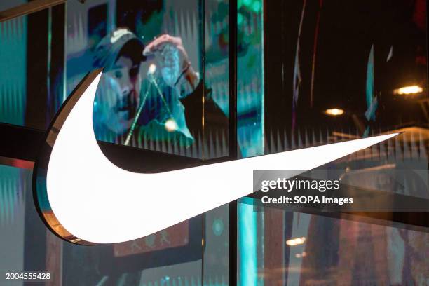 Illuminated trademark of the American athletic footwear and apparel corporation Nike, Inc. Seen on the Nike Store window in Antwerp, Belgium.