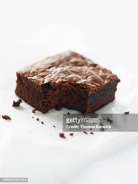 double-chocolate brownie missing one bite, elevated view - brownie stockfoto's en -beelden