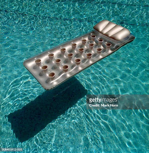 air matress floating in swimming pool - pool raft imagens e fotografias de stock