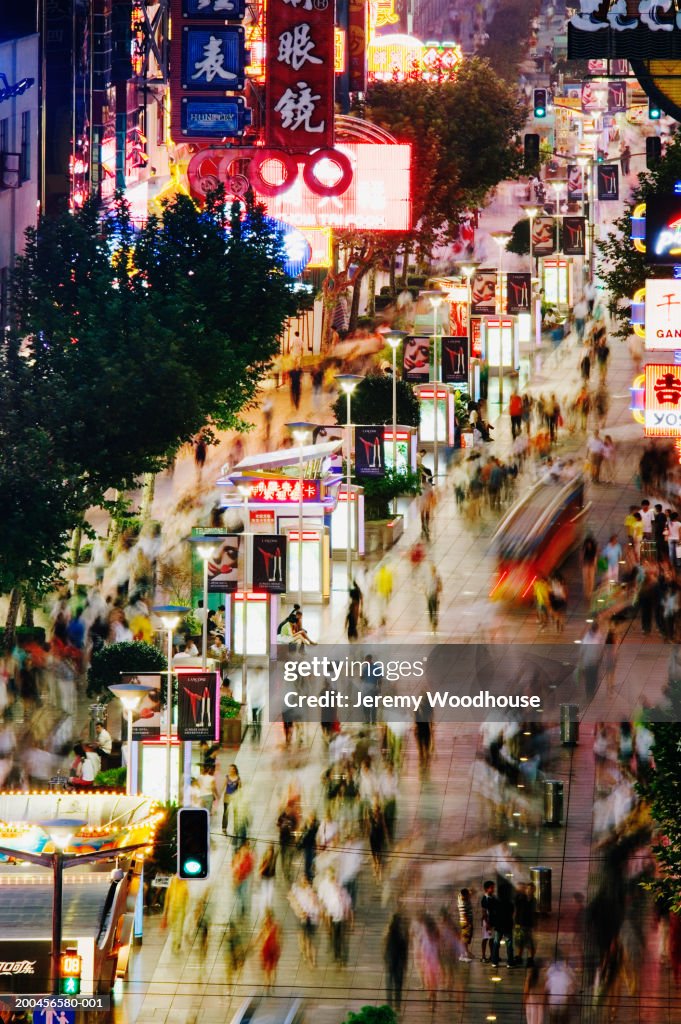 China, Shanghai, Nanjing Road, street scene at dusk (blurred motion)