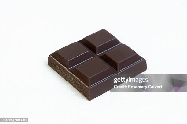 four squares of dark chocolate, close-up - dark chocolate stock pictures, royalty-free photos & images