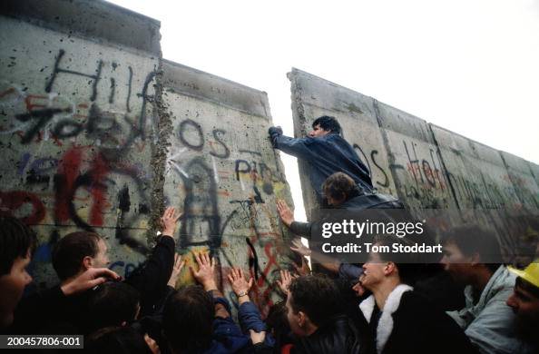 First section of Berlin Wall pushed down by crowds. First section of Berlin Wall pushed down by crowds.