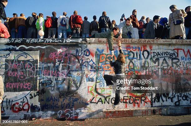 Crowds gathering on Berlin Wall They are on a section of the wall near the Brandenburg Gate – a high profile location where, for cosmetic reasons,...