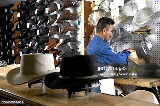 hatter shaping stetson in workshop, rear view - milliner stock pictures, royalty-free photos & images