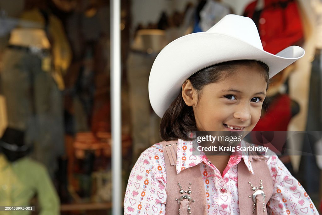 Girl (8-10) wearing stetson, smiling