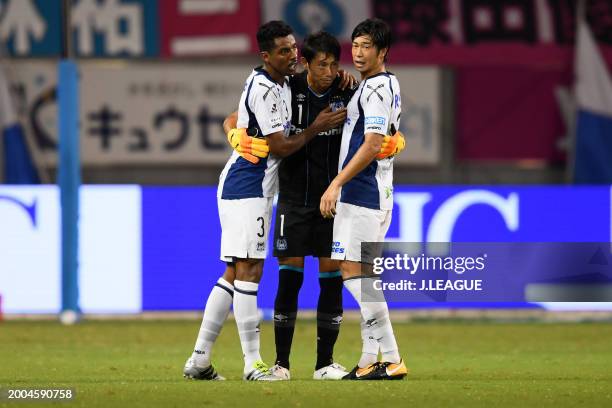 Fabio, Masaaki Higashiguchi and Genta Miura of Gamba Osaka celebrate the team's 3-1 victory in the J.League J1 match between Sagan Tosu and Gamba...
