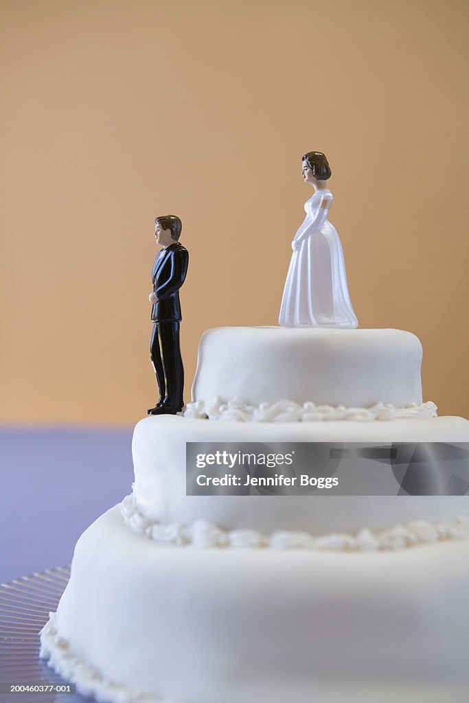 Wedding cake with groom and bride on different levels