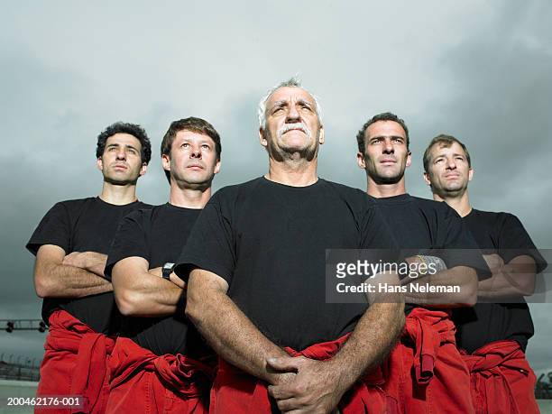 racing team mechanics looking upwards - cinco pessoas imagens e fotografias de stock