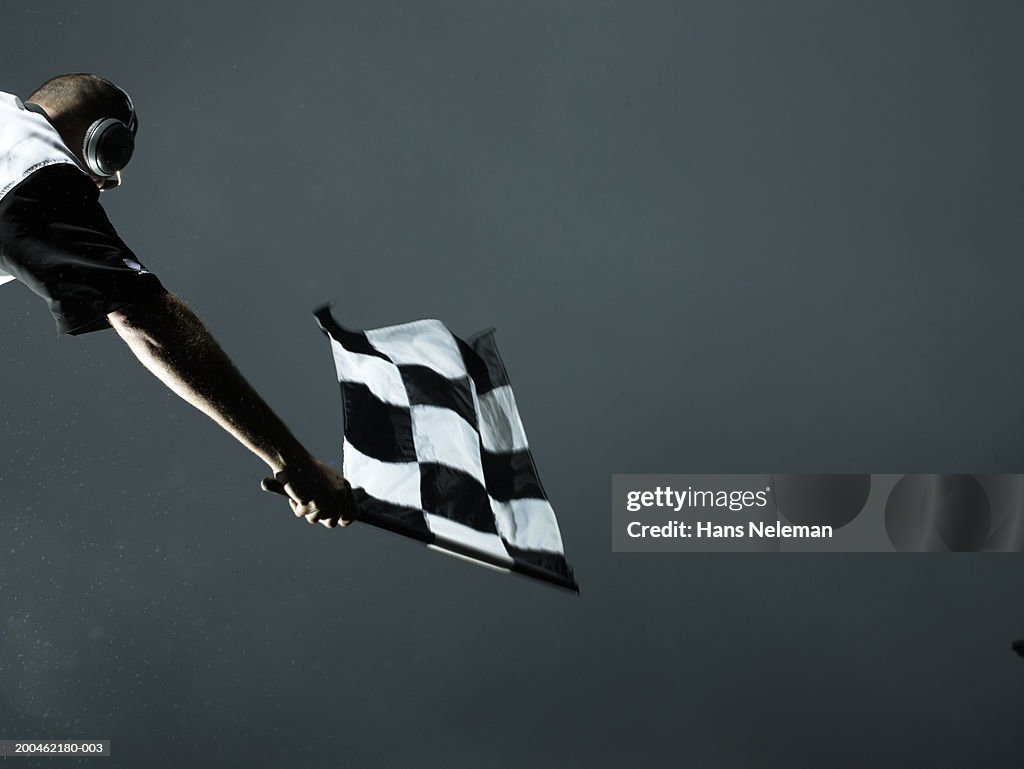 Racing official waving checkered flag
