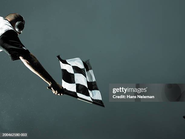 racing official waving checkered flag - chequered flag stock pictures, royalty-free photos & images