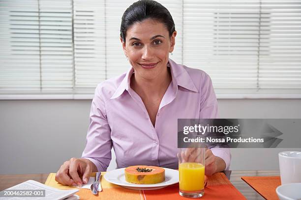 woman at breakfast table, portrait - purple shirt stock pictures, royalty-free photos & images