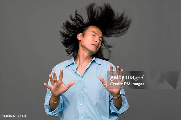 man with eyes closed tossing hair back - hair toss stock pictures, royalty-free photos & images