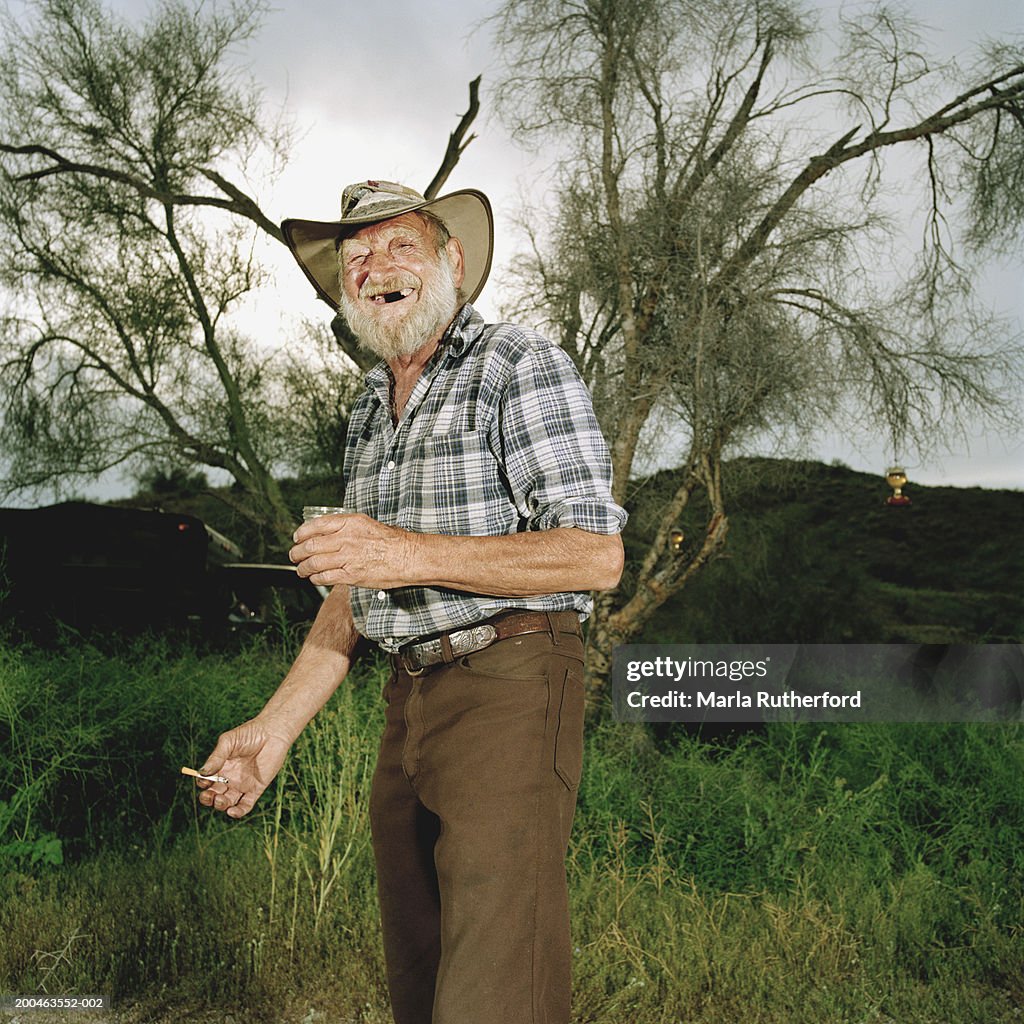 Senior man standing in field