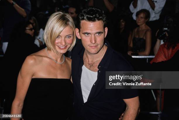 American actress Cameron Diaz, wearing a black tube top, and American actor Matt Dillon, who wears a white t-shirt beneath a black shirt, attend the...