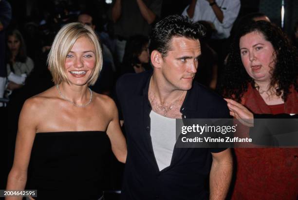 American actress Cameron Diaz, wearing a black tube top, and American actor Matt Dillon, who wears a white t-shirt beneath a black shirt, attend the...