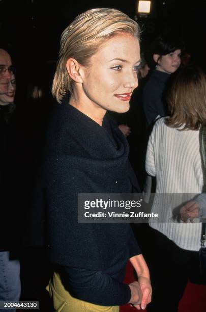 Actress Cameron Diaz, wearing a black jacket, attends the Westwood premiere of 'The People vs Larry Flynt', held at the Mann Village Theatre in the...