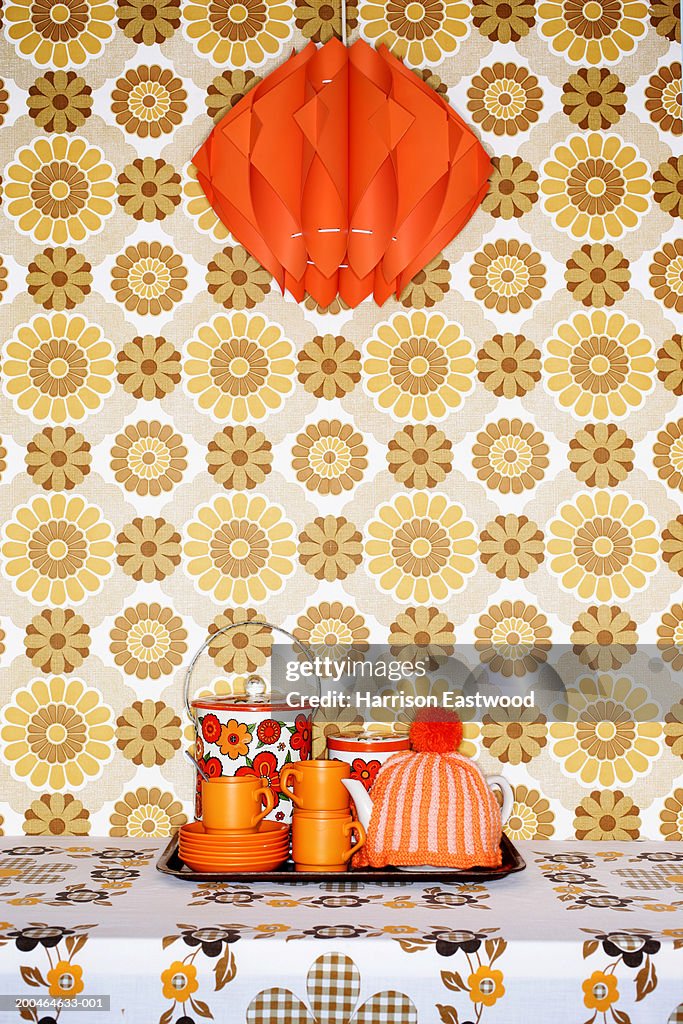 Tea tray on table with patterned table cloth under red light shade
