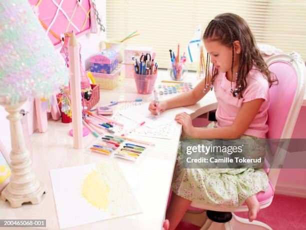 girl (6-8) coloring at desk in bedroom, side view, close-up - art and craft stock pictures, royalty-free photos & images