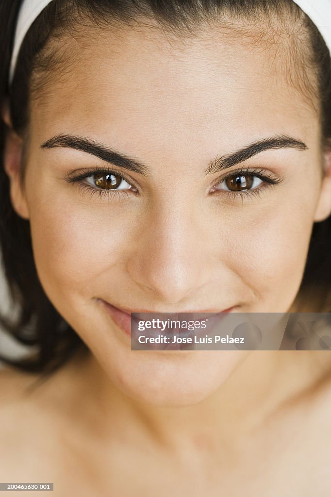 Teenage girl (14-16) smiling, close-up, portrait