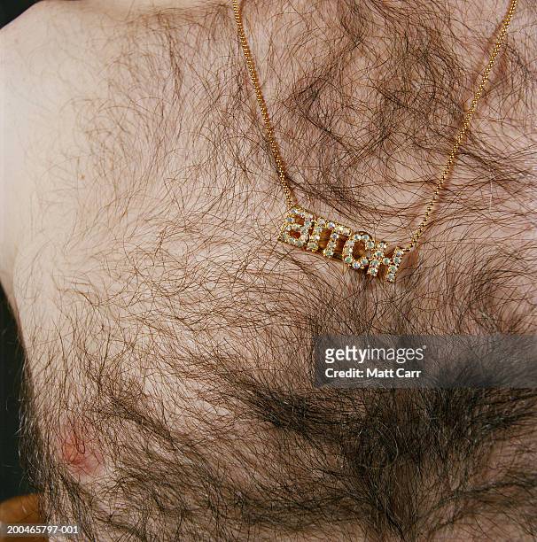 man wearing necklace spelling'bitch', mid section, close-up - hairy chest man stock pictures, royalty-free photos & images