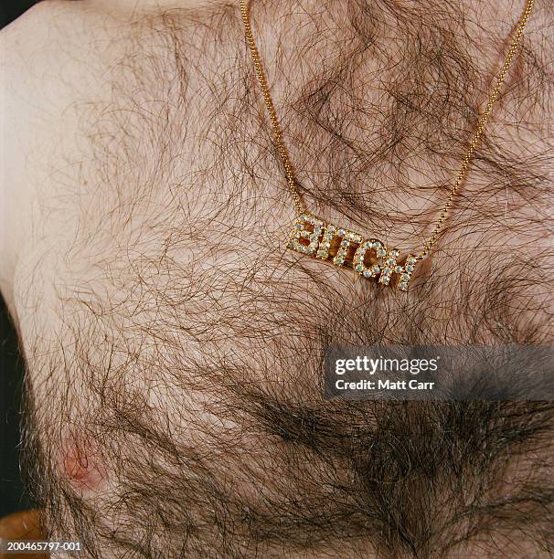 man wearing necklace spelling'bitch', mid section, close-up - bling bling imagens e fotografias de stock