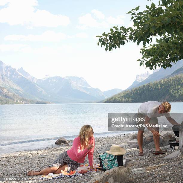 man and woman cooking on beach - waterton lakes national park stock pictures, royalty-free photos & images