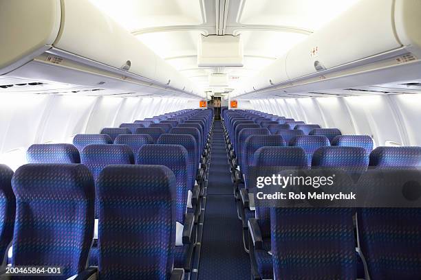 rows of empty seats on airplane - vehicle interior stock-fotos und bilder